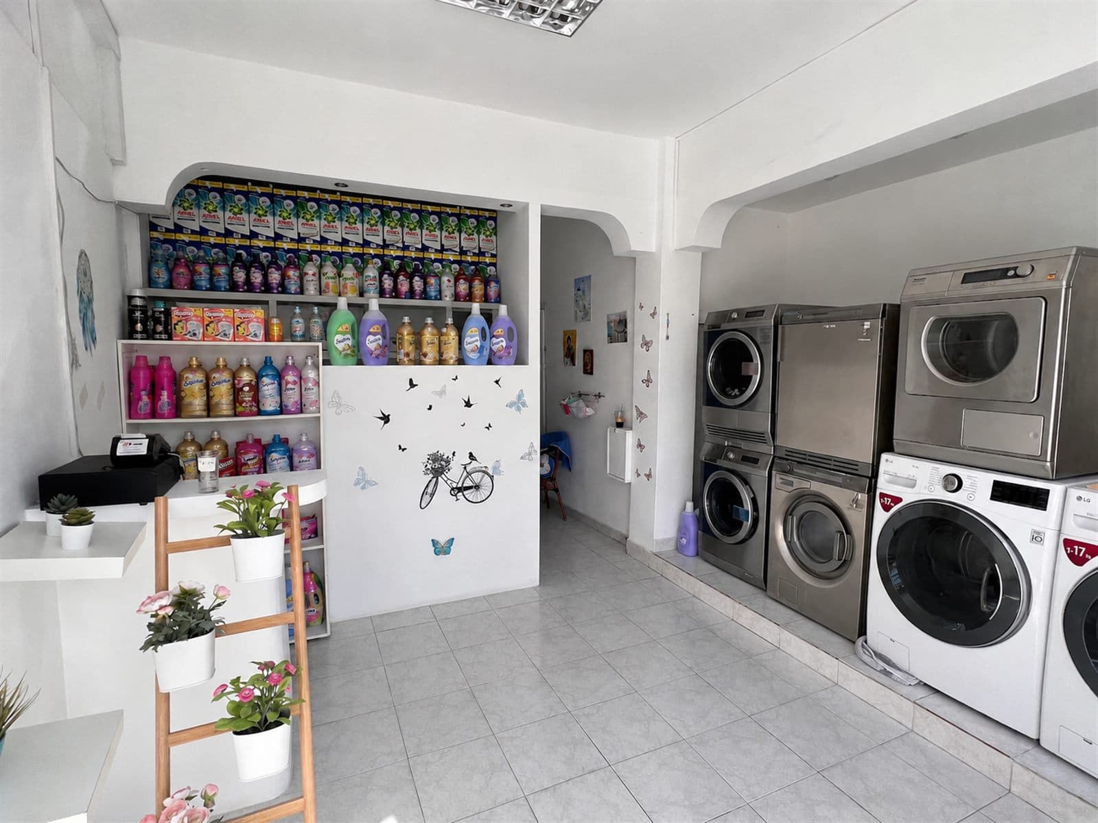 Illustration of fresh laundry drying on a line by the sea in Perissa